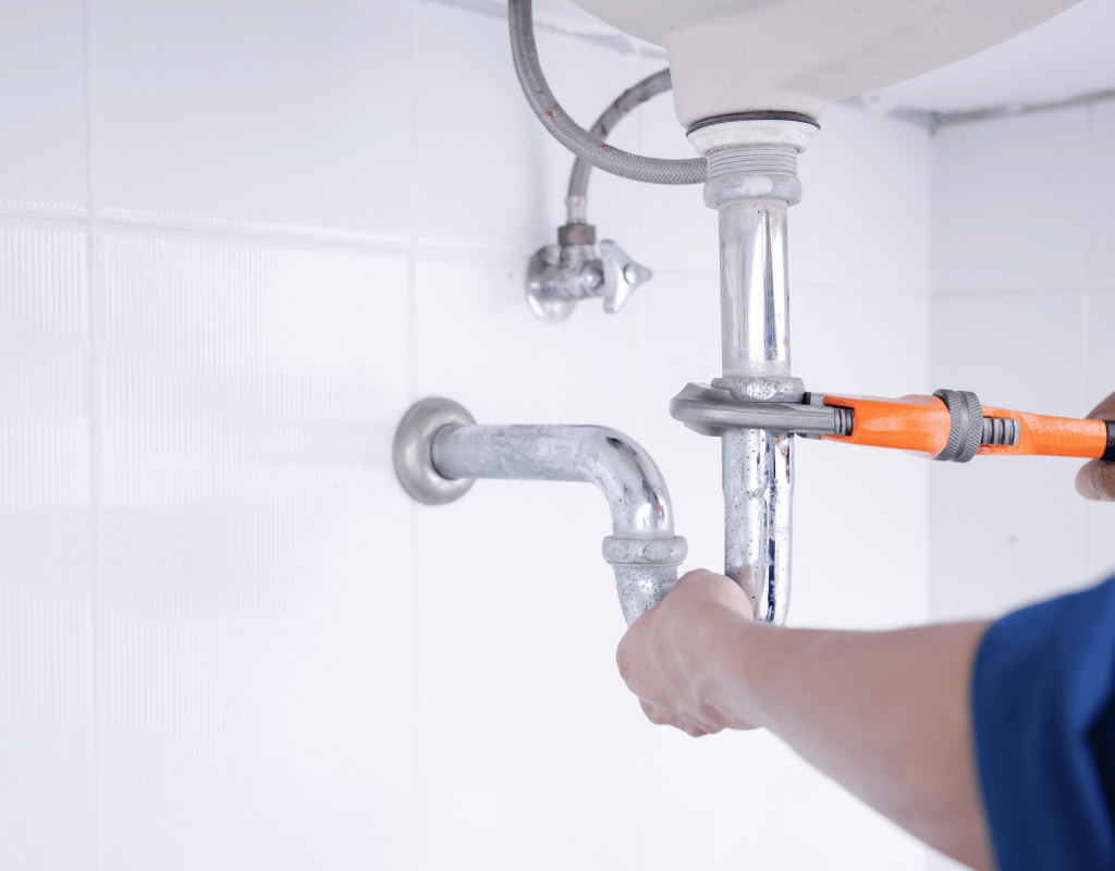 Native Plumbing LLC Jefferson County TN Fixture & Appliance Installation – plumber connecting sink drain line.