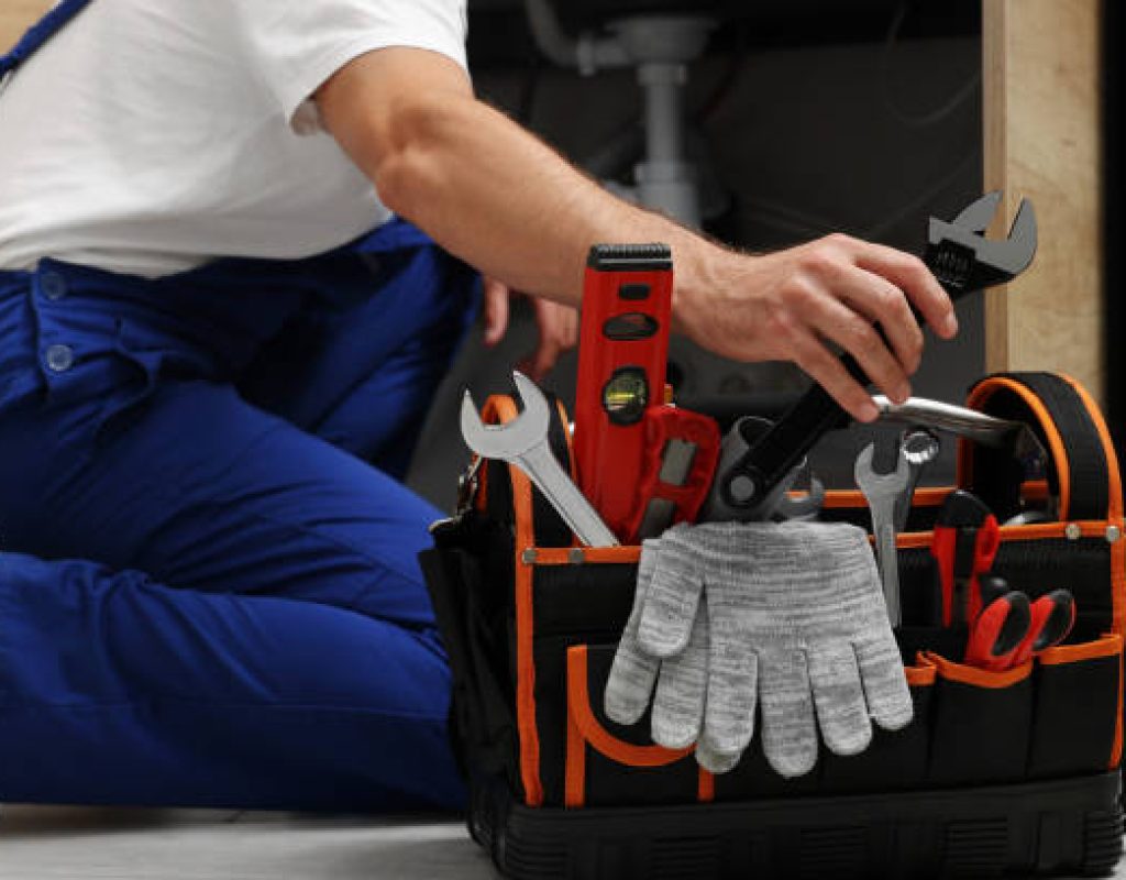 certified plumber performing routine maintenance on household plumbing fixtures