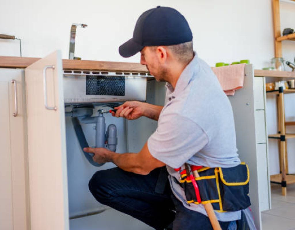 Native Plumbing LLC completing water heater repair for residential homeowner